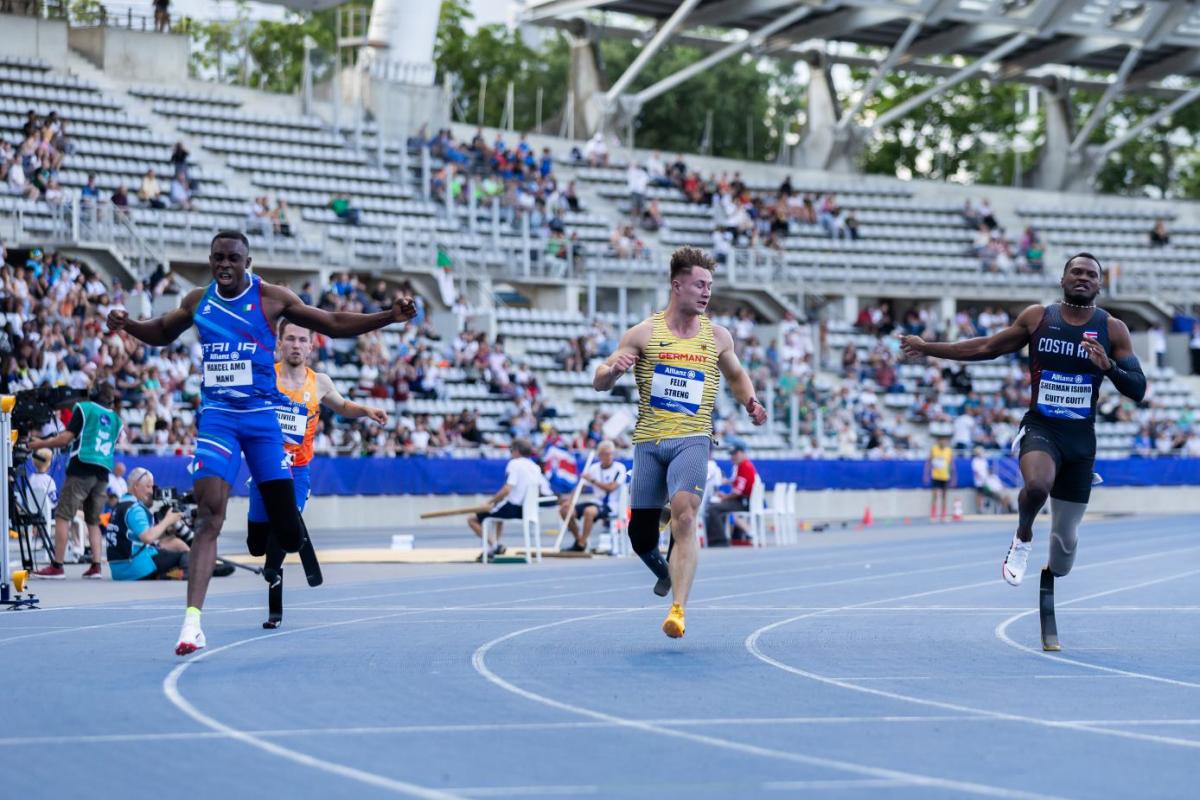 Three male blade runners in a Para athletics race