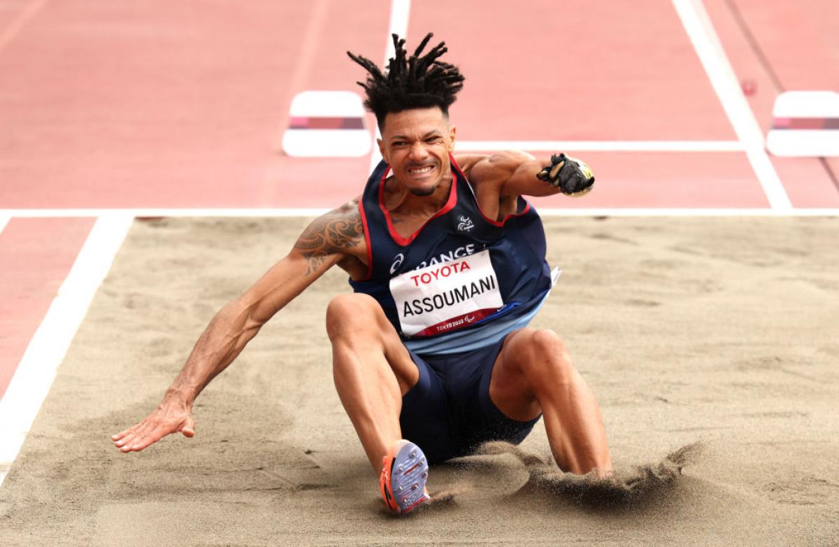 A male long jumper lands his jump at the Tokyo 2020 Paralympic Games.