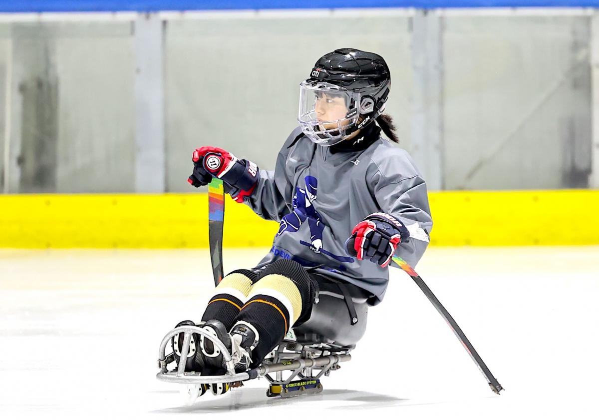 A female Para ice hockey player on a rink