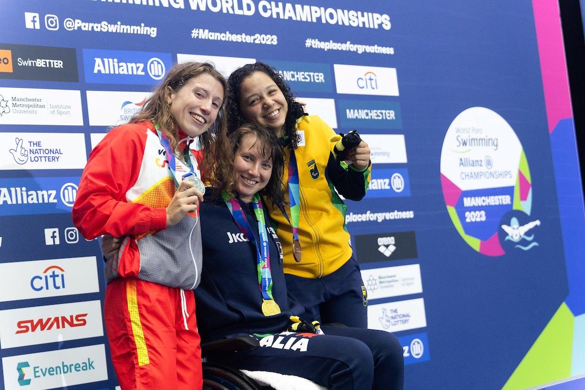 Three female athletes on a podium 