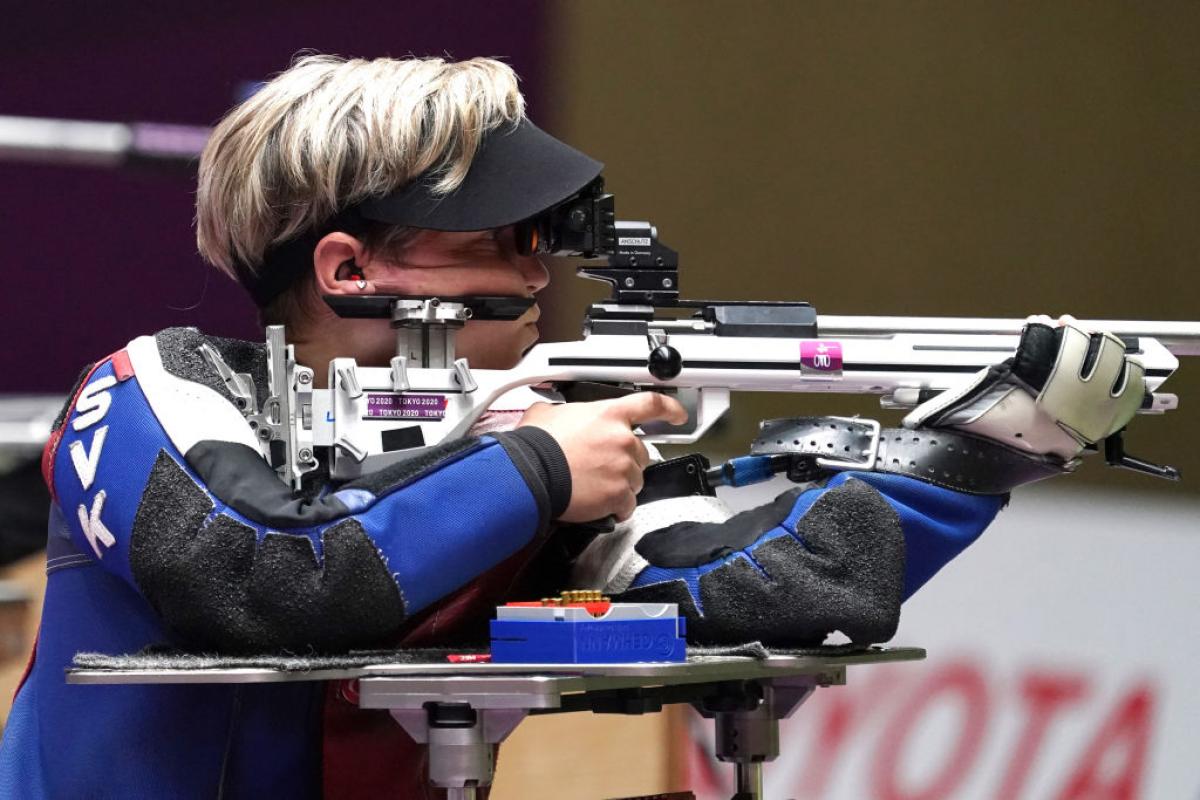 A female athlete competing in a shooting rifle event