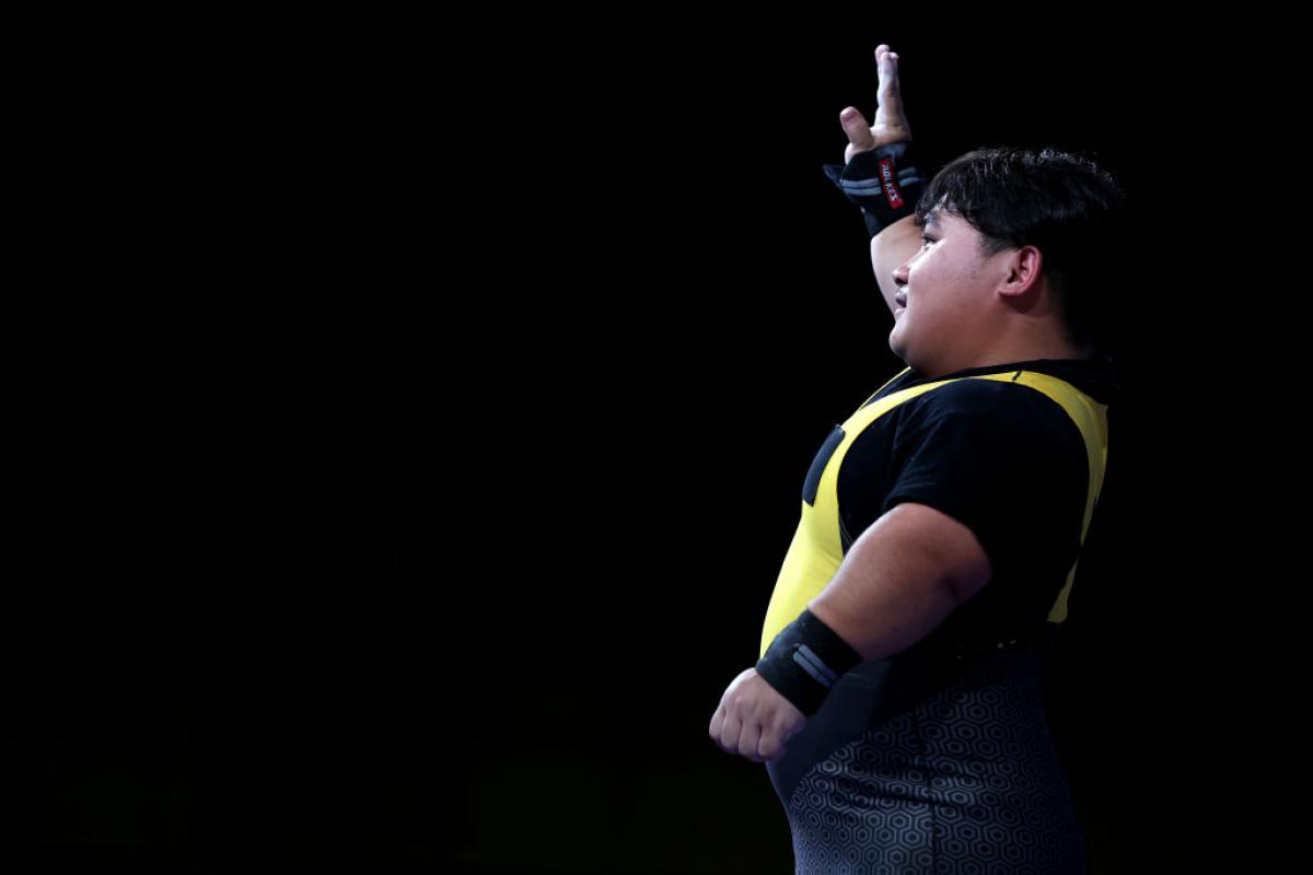 A male powerlifter waving 