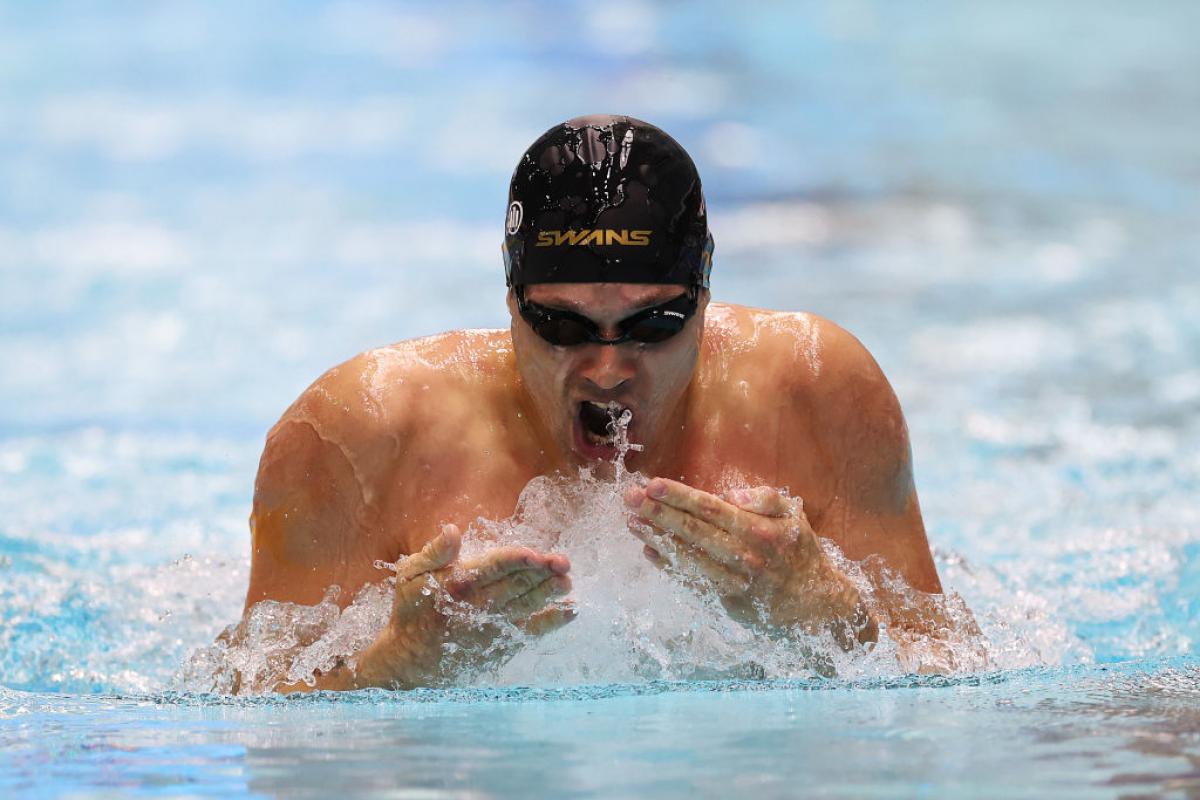 A male athlete swimming breaststroke