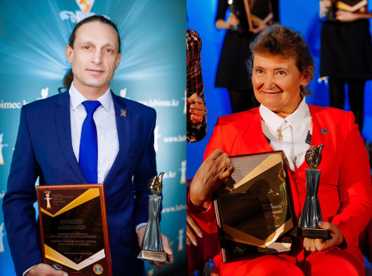 A man and a woman in a wheelchair holding trophies