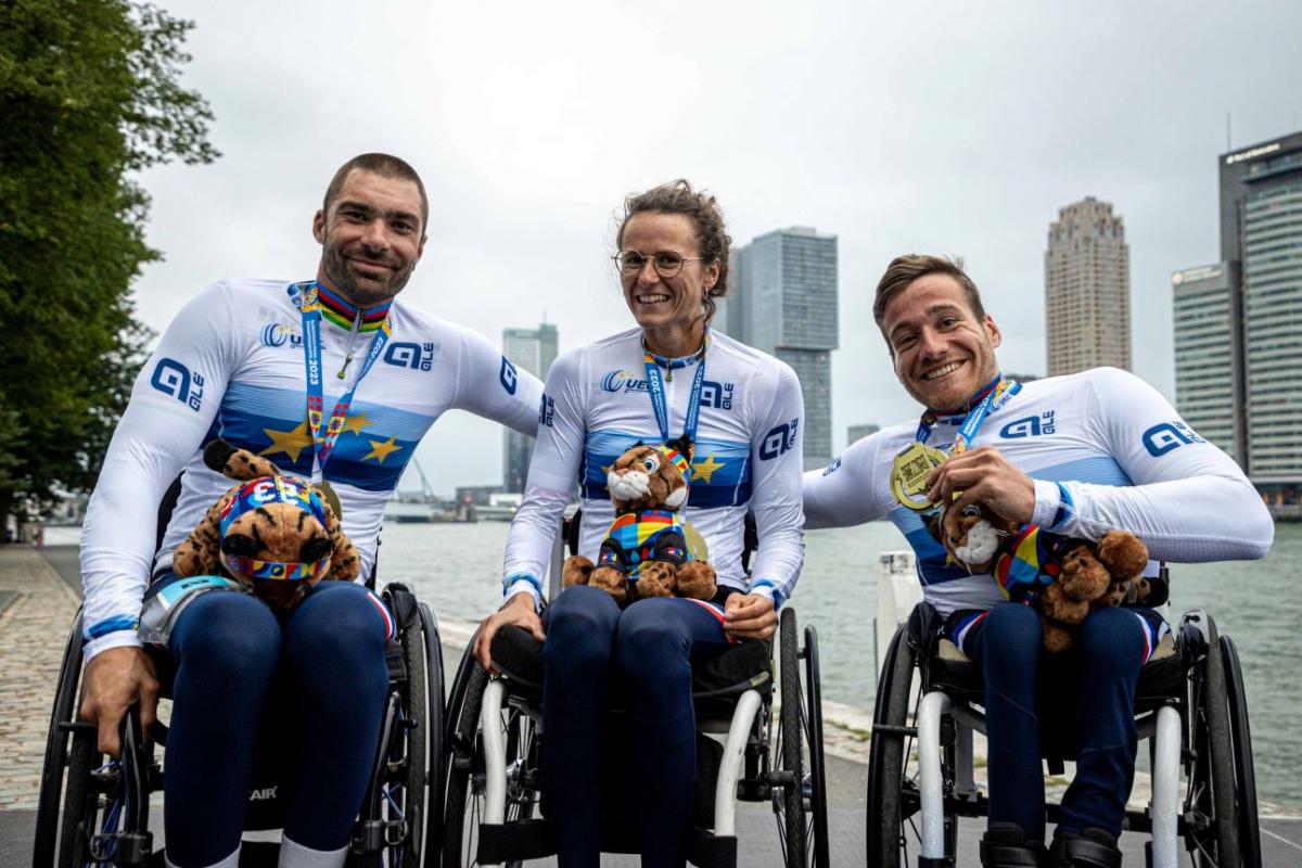 Three Para athletes posing for a photo after receiving gold medals and a European champion shirt