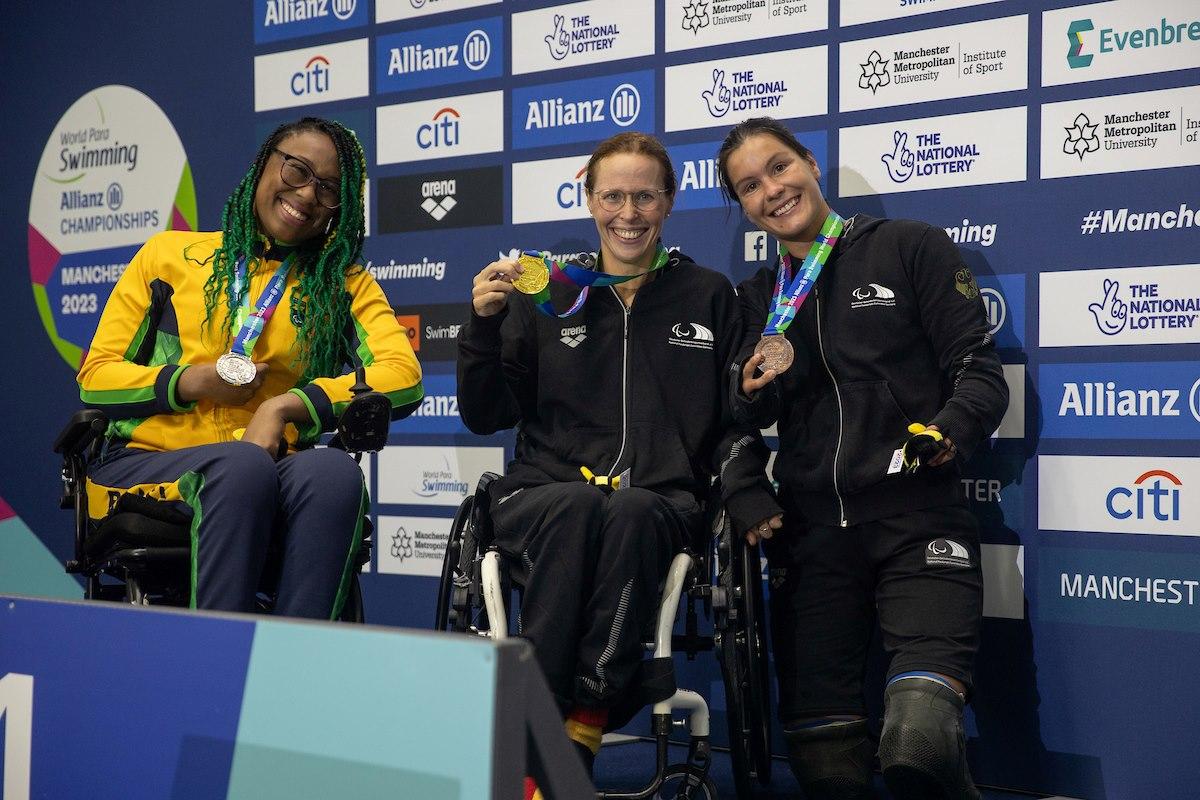 Three women on a podium with their medals