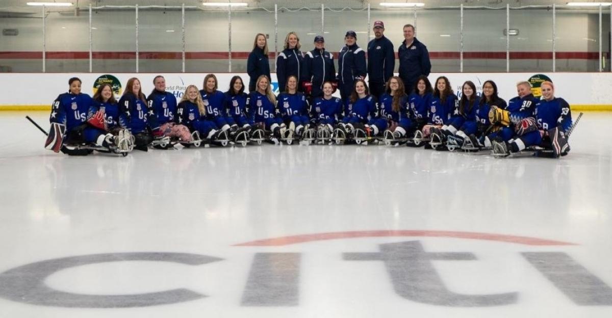 The USA women's Para ice hockey national team in a team picture on an ice rink