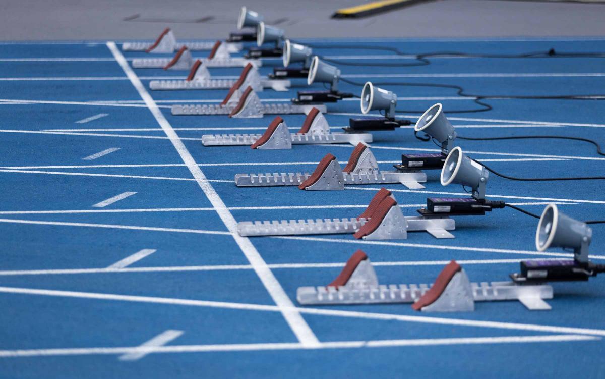 The starting blocks on a blue athletics track