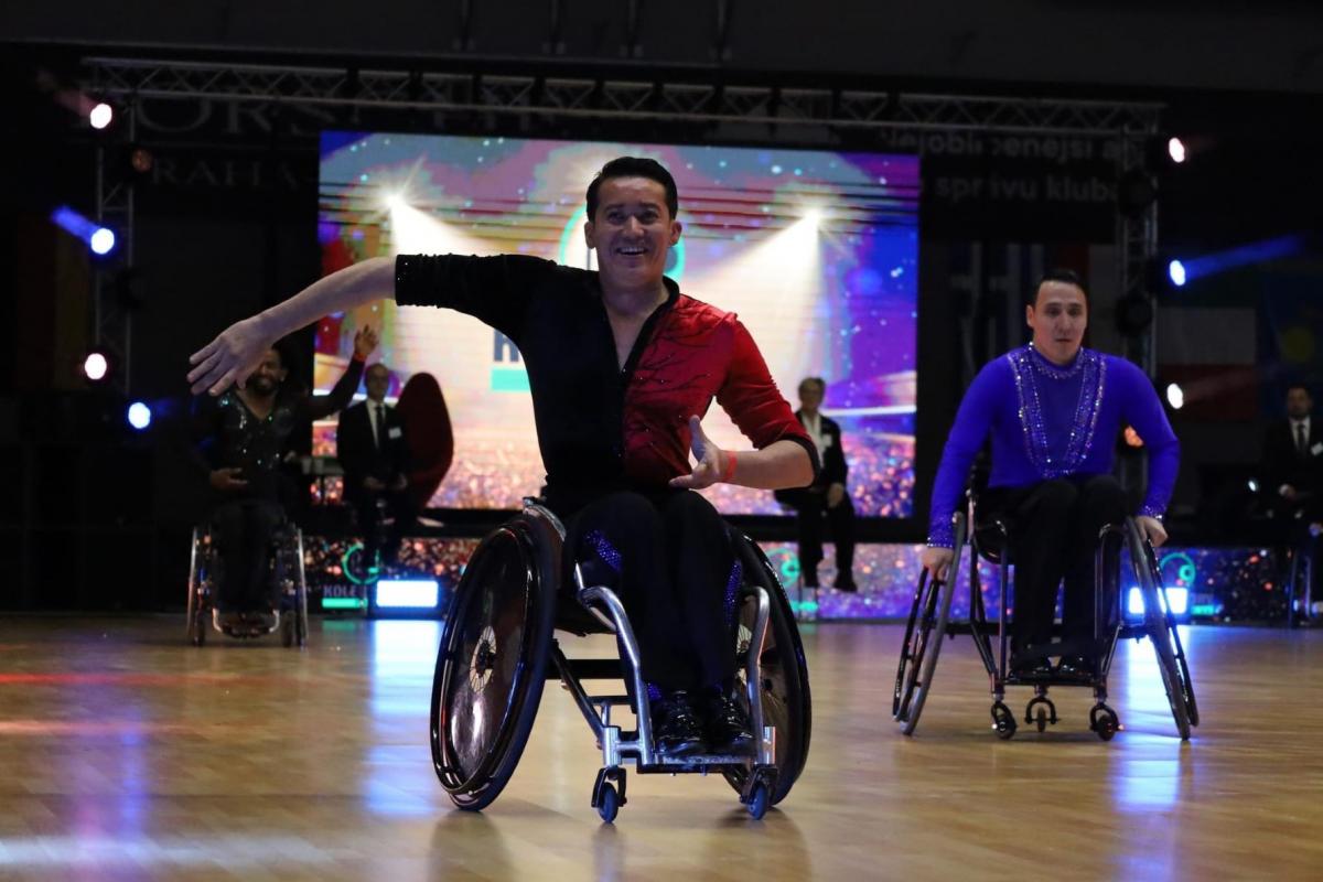 A male wheelchair dancer in a competition with another male dance in the background