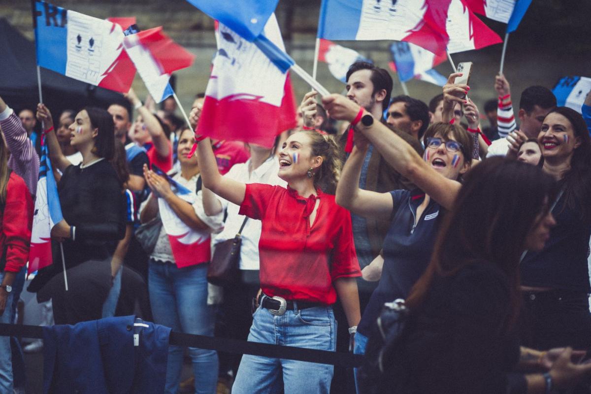 French fans waving flags in Paris.