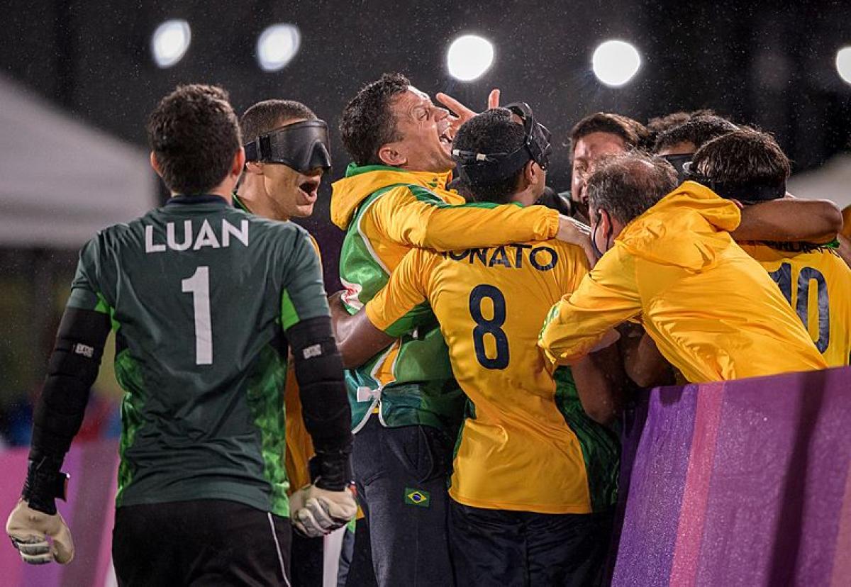 Eight blind football athletes gather to celebrate at the Tokyo 2020 Paralympics.