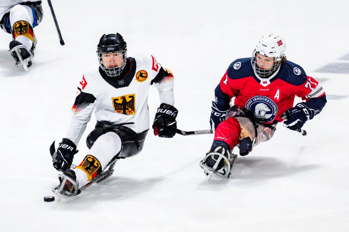 Two male Para ice hockey players from Germany and Norway on ice