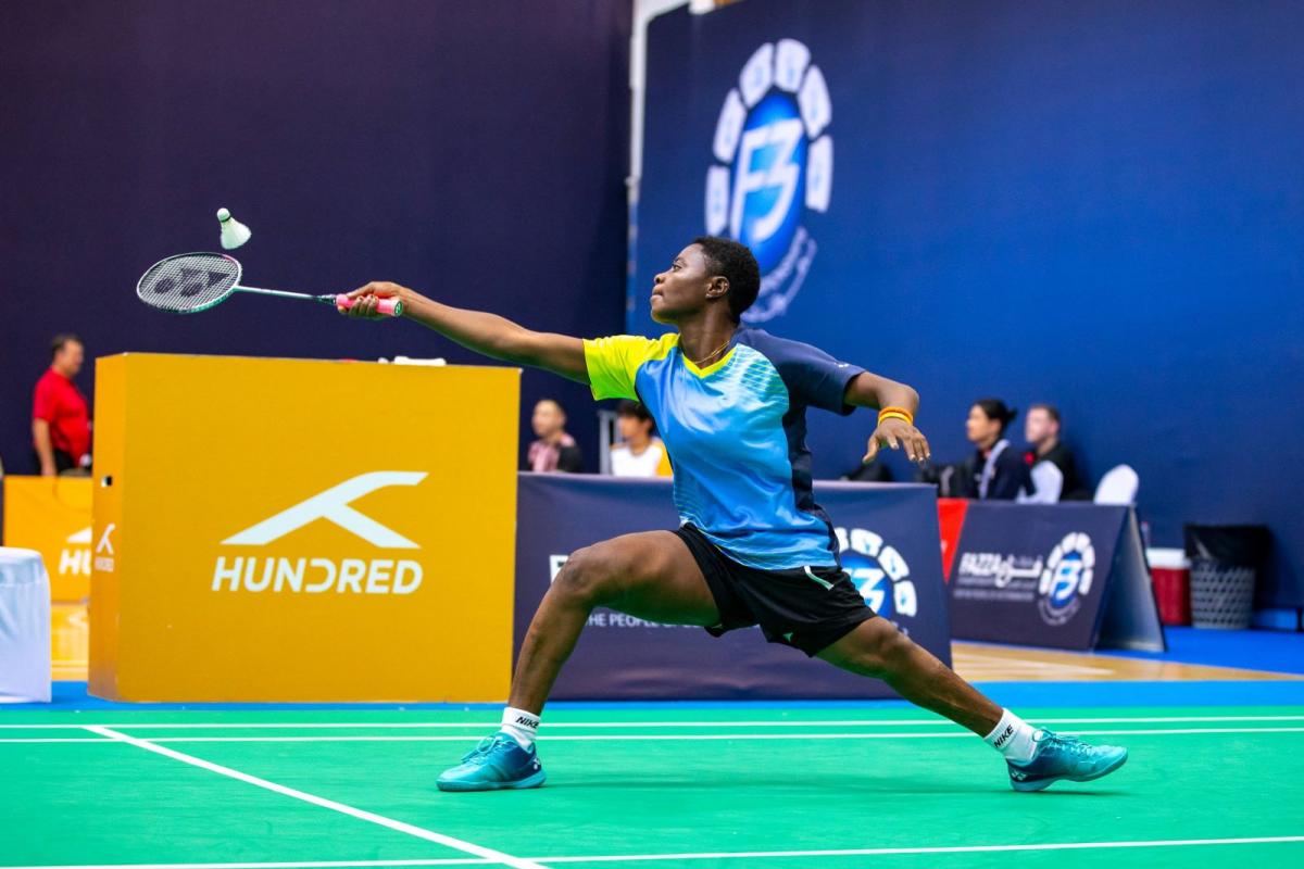 A female badminton athlete in action.