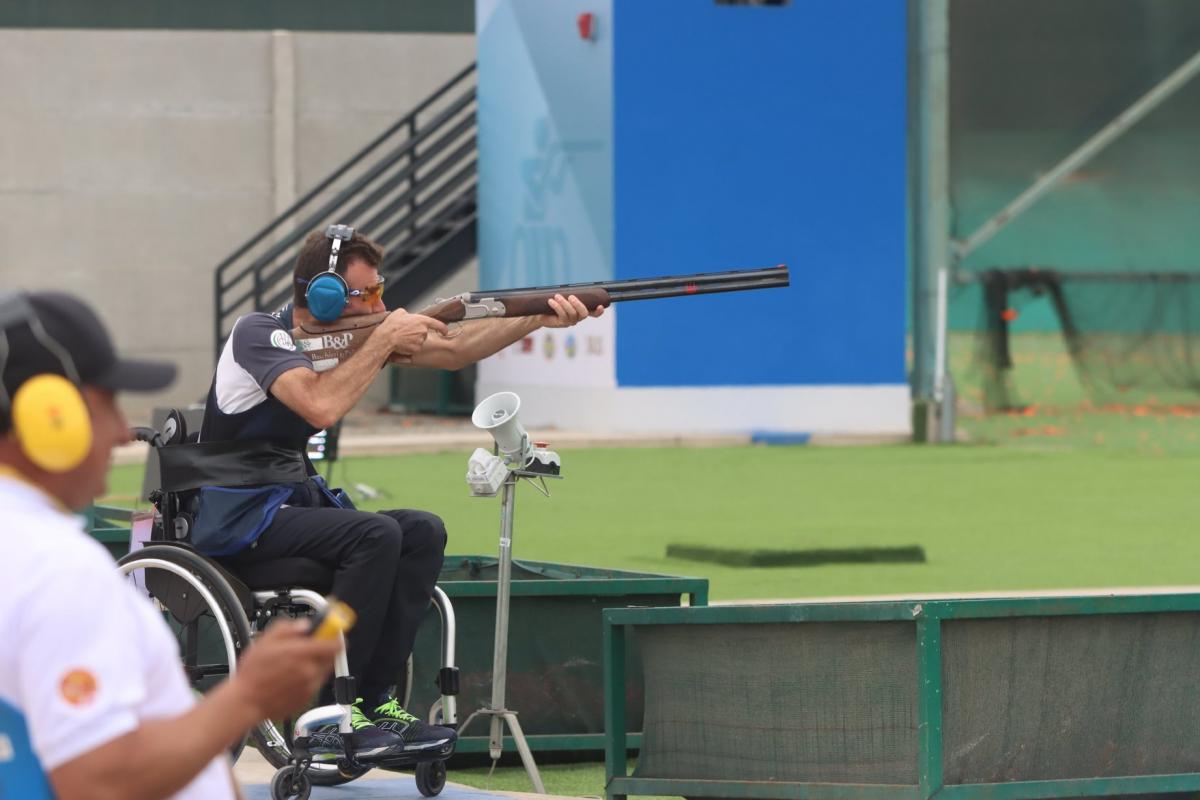 A man in a wheelchair competing in a Para trap event