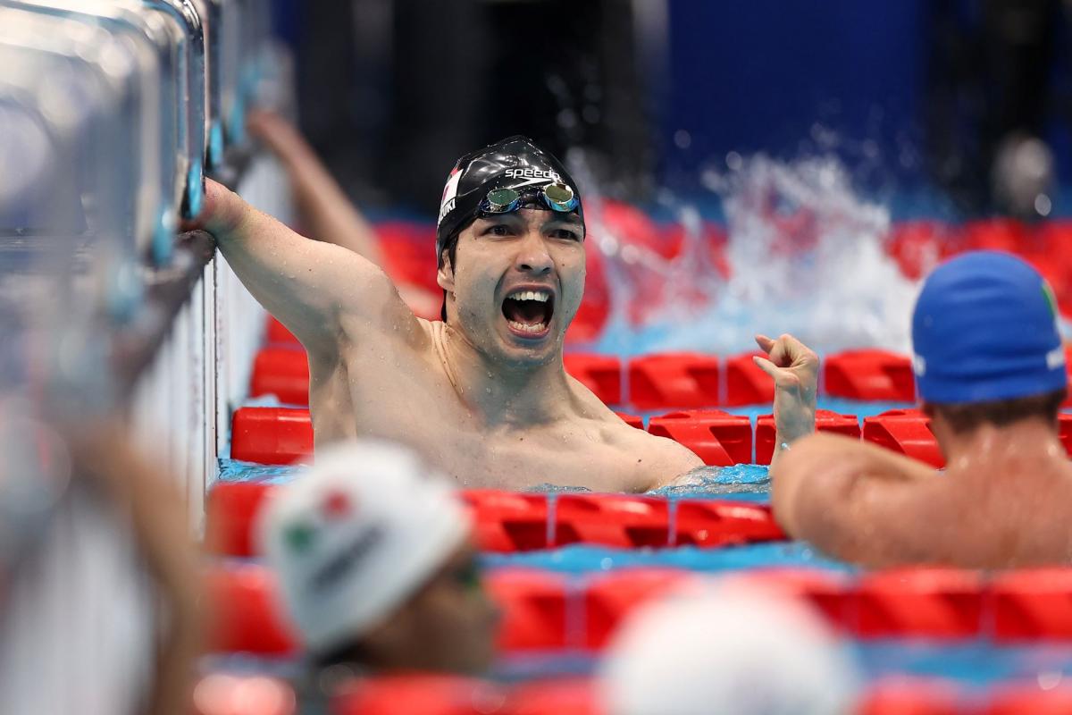 A male swimmer celebrates after touching the wall at the Tokyo 2020 Paralympics.