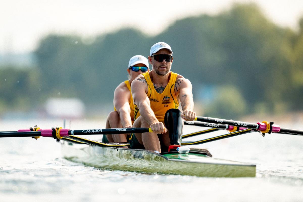 Two Para rowers - a male athlete and a female athlete - compete.