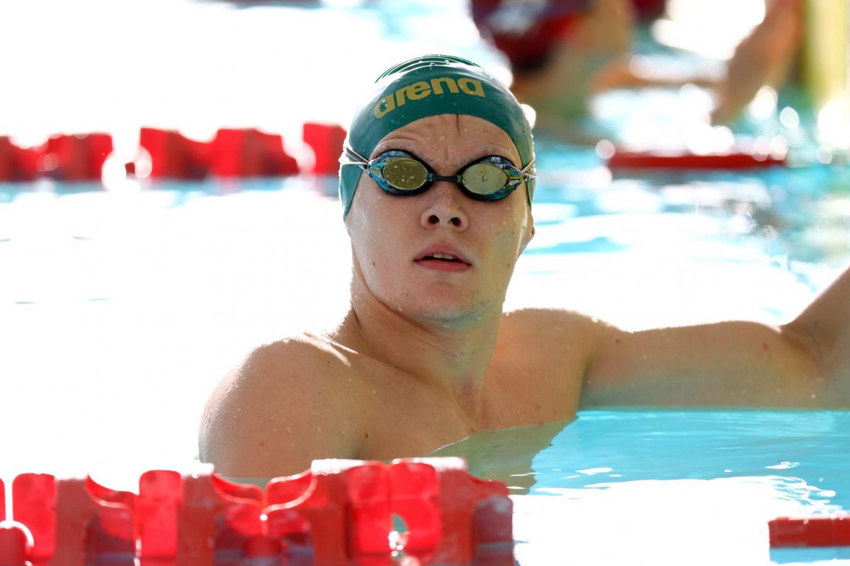 A male swimmer with his head outside the water