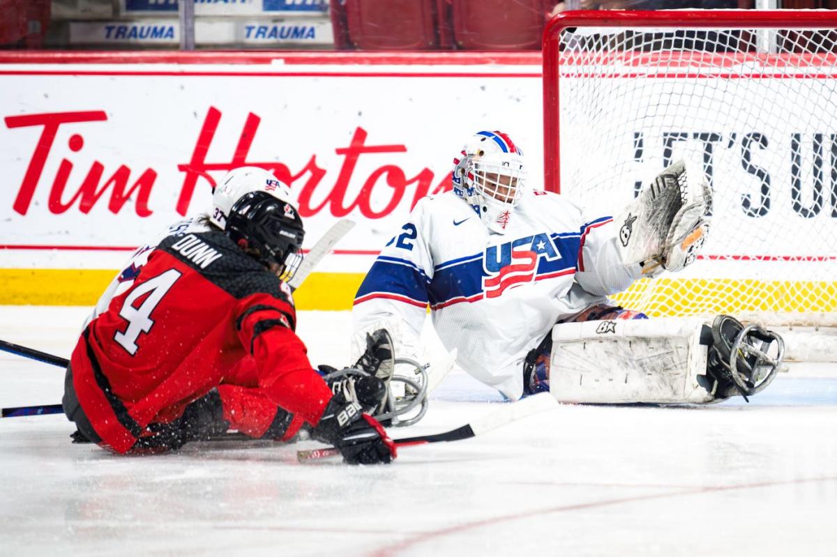 A hockey goaltender making a save from an opponent's shot