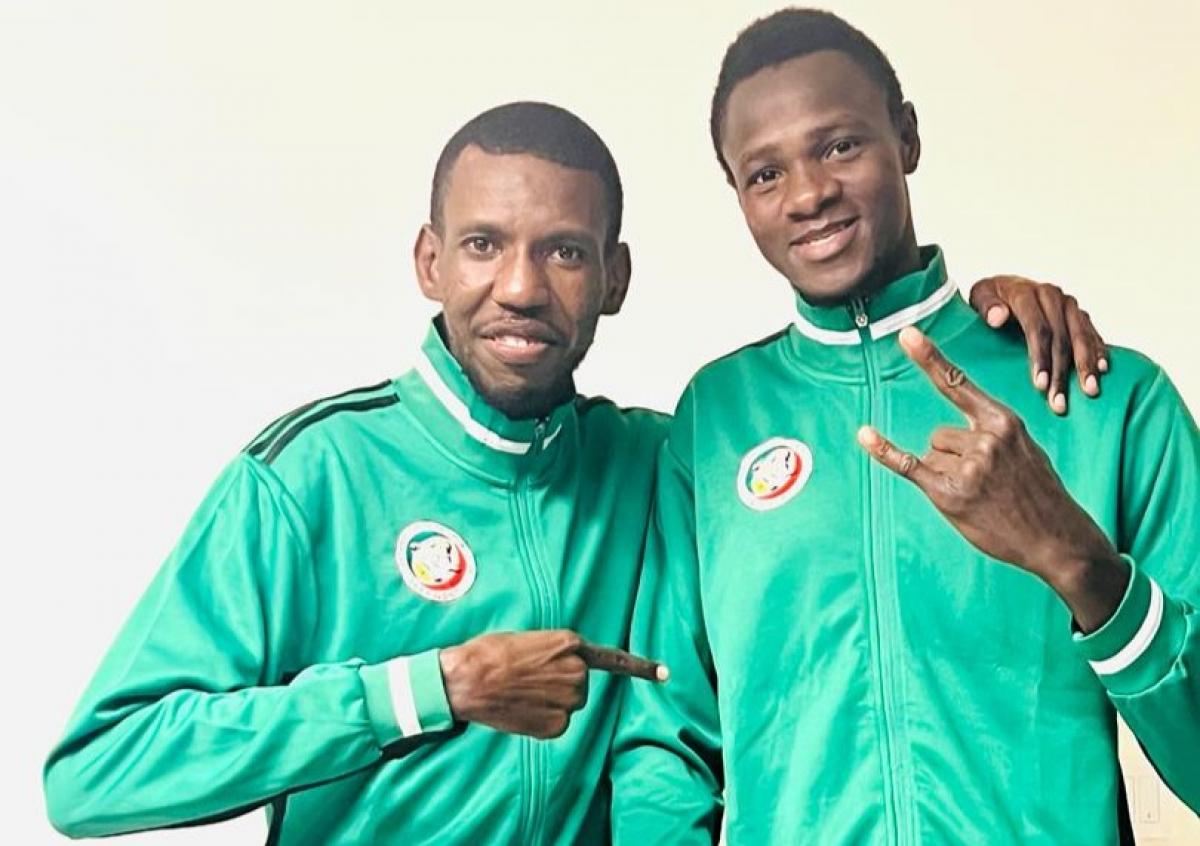 Idrissa Keita, a Para taekwondo athlete from Senegal, and his coach pose for a photograph