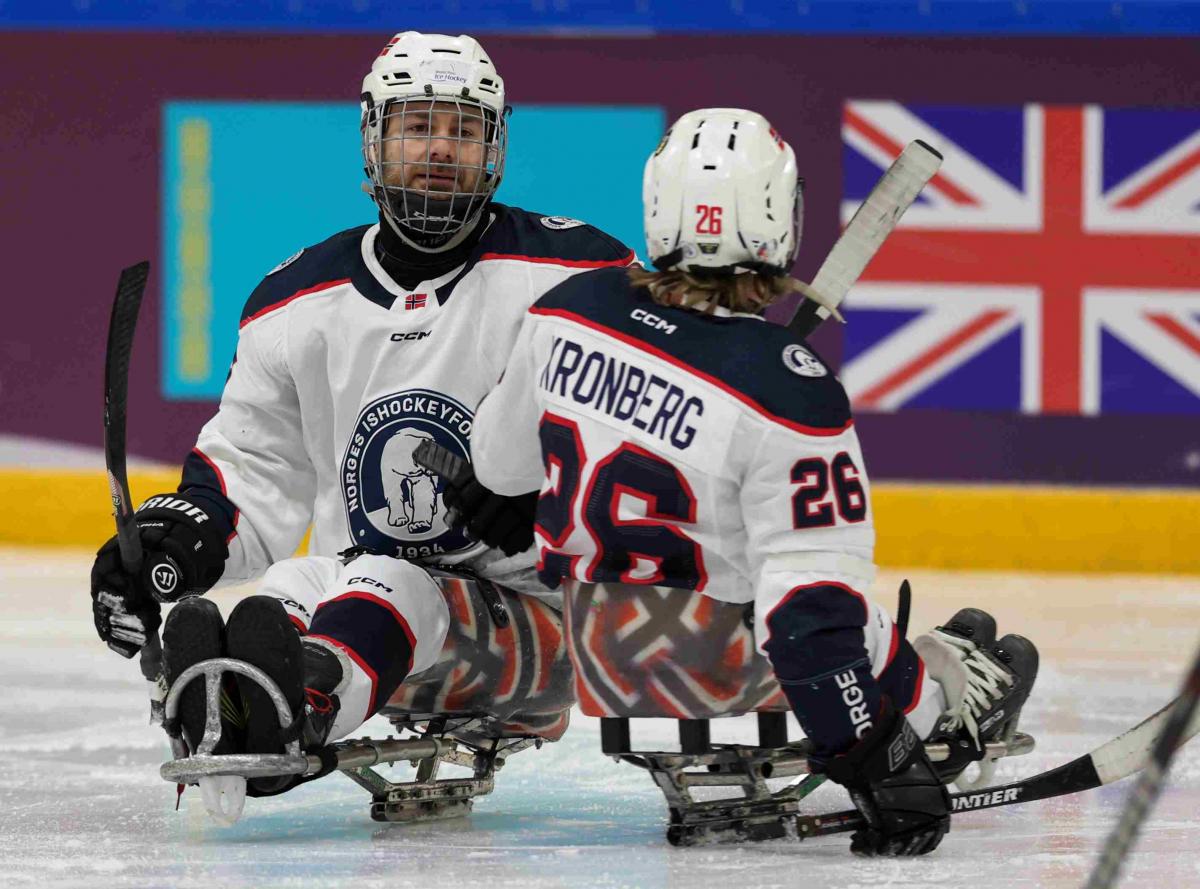 Para Ice Hockey players celebrate a goal