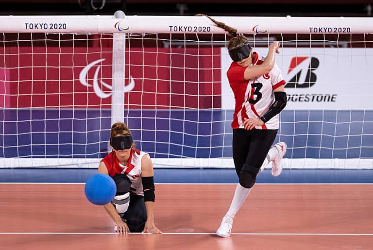 Goalball player Sevda Altunoluk stands and throws the ball 