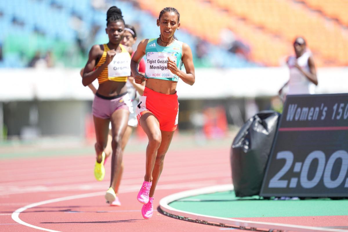 A female runner ahead of two competitors