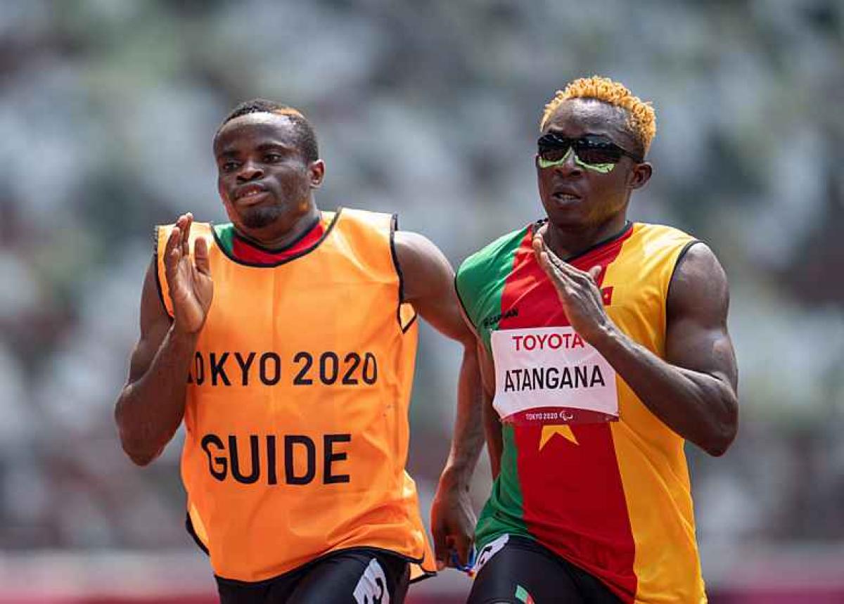 Vision impaired sprinter Guillaume Junior Atangana running with his guide