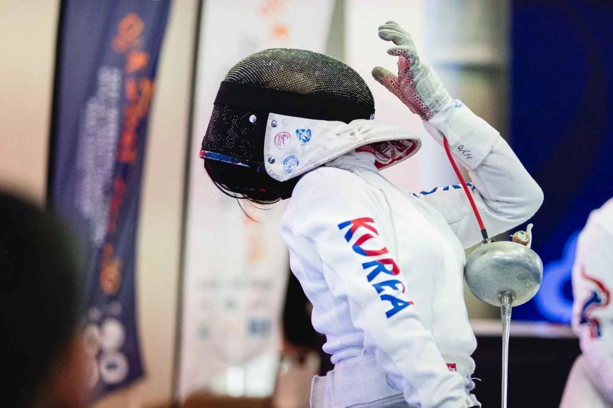 a south korean female wheelchair fencer in action 