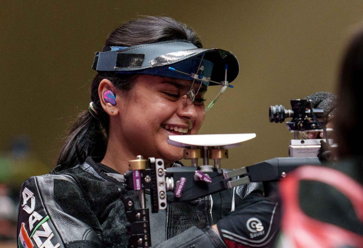An athlete gestures after winning a rifle event