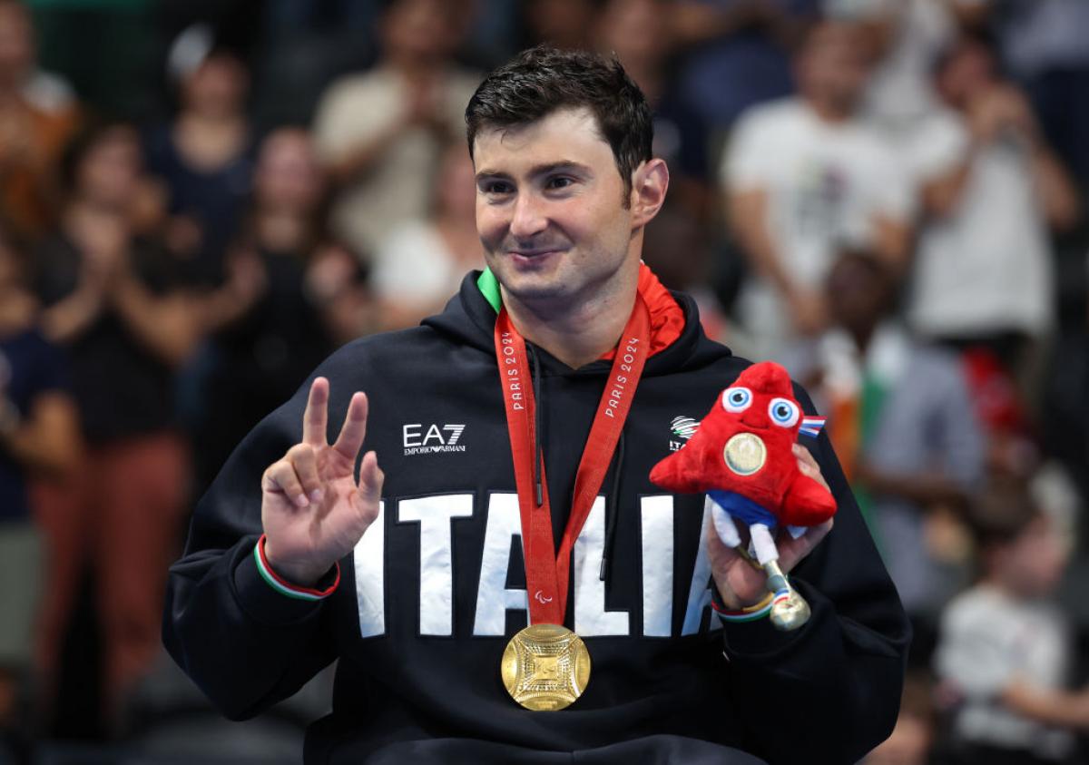 Francesco Bocciardo poses for the camera with his gold medal