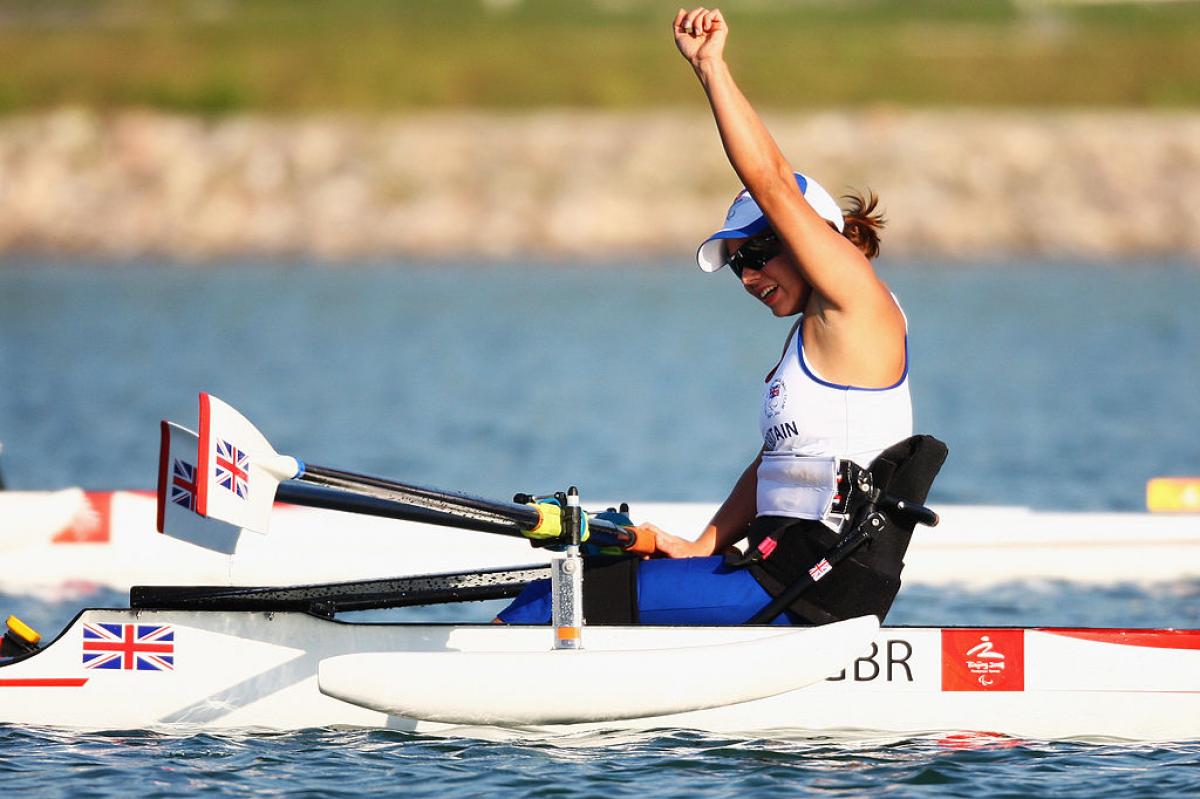 A female Para rowing athlete reacts after a competition