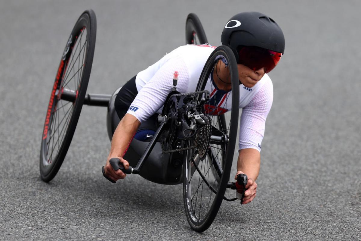 A woman races in a handcycle at Tokyo 2020