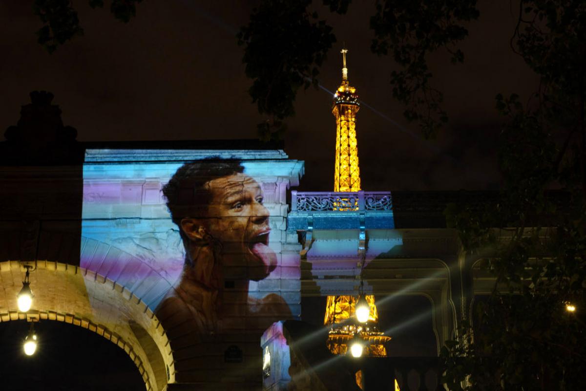 A projection of Brazilian swimmer Gabriel Araujo near the Eiffel Tower
