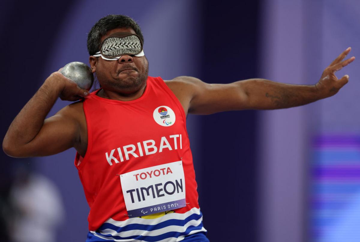 Blindfolded Para athlete Ongiou Timeon gets ready to throw a shot put