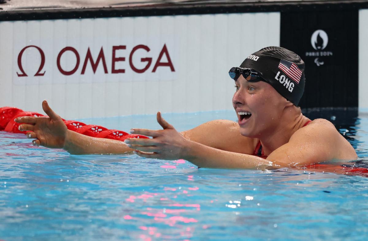 A female swimmer stretching her arms inside the pool