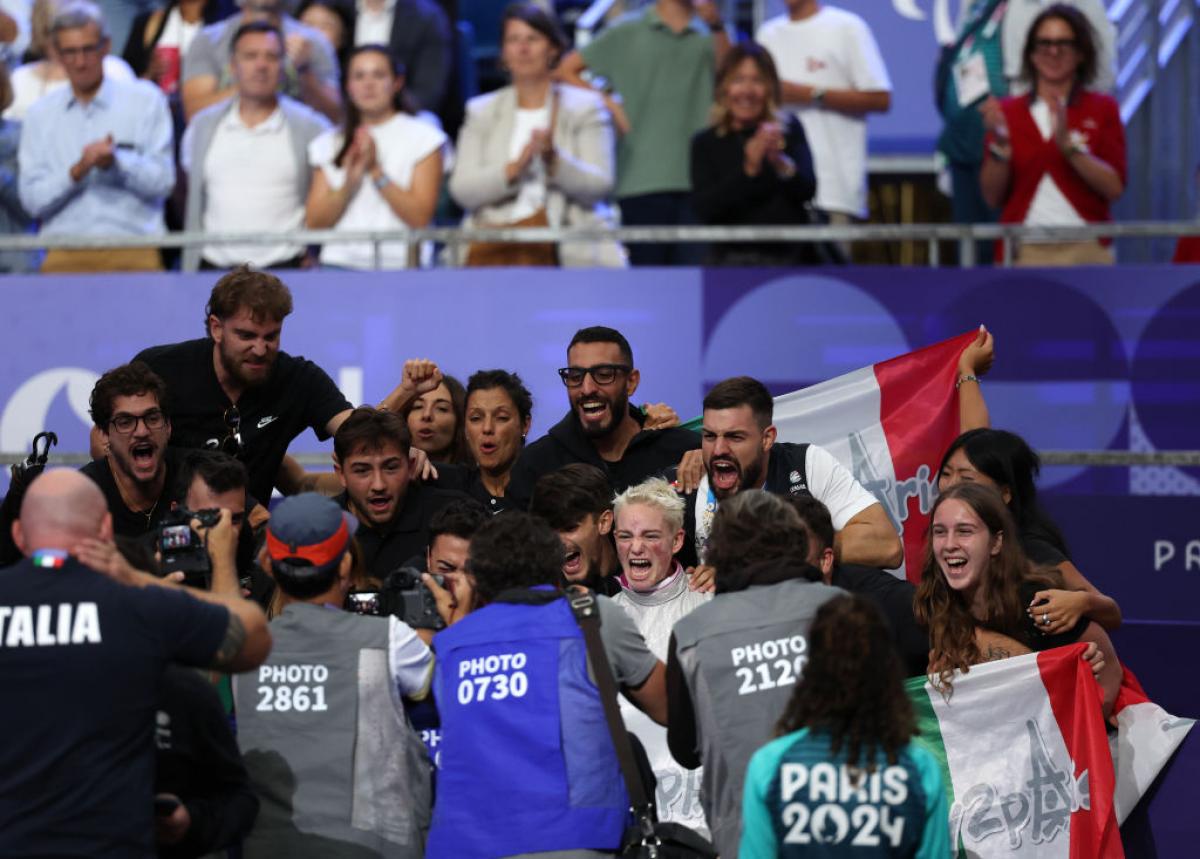 Bebe Vio cheering surrounded by fans and photographers
