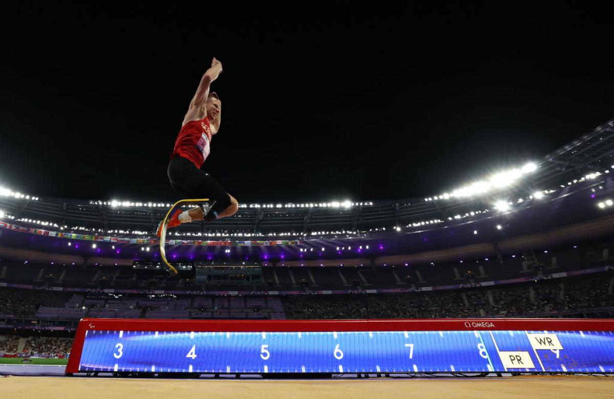 A man with a prosthetic leg competing in the long jump at Stade de France