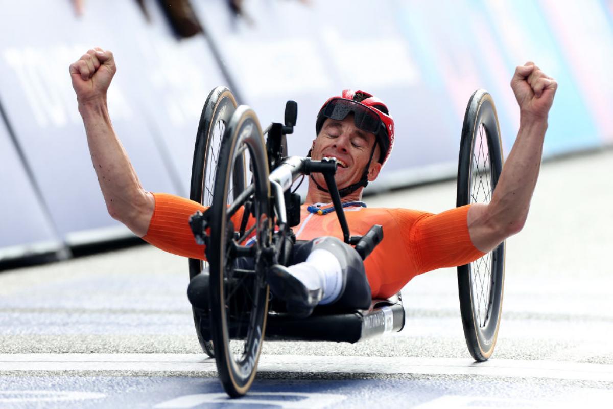 Para cyclist Jetze Plat celebrates crossing the finish line