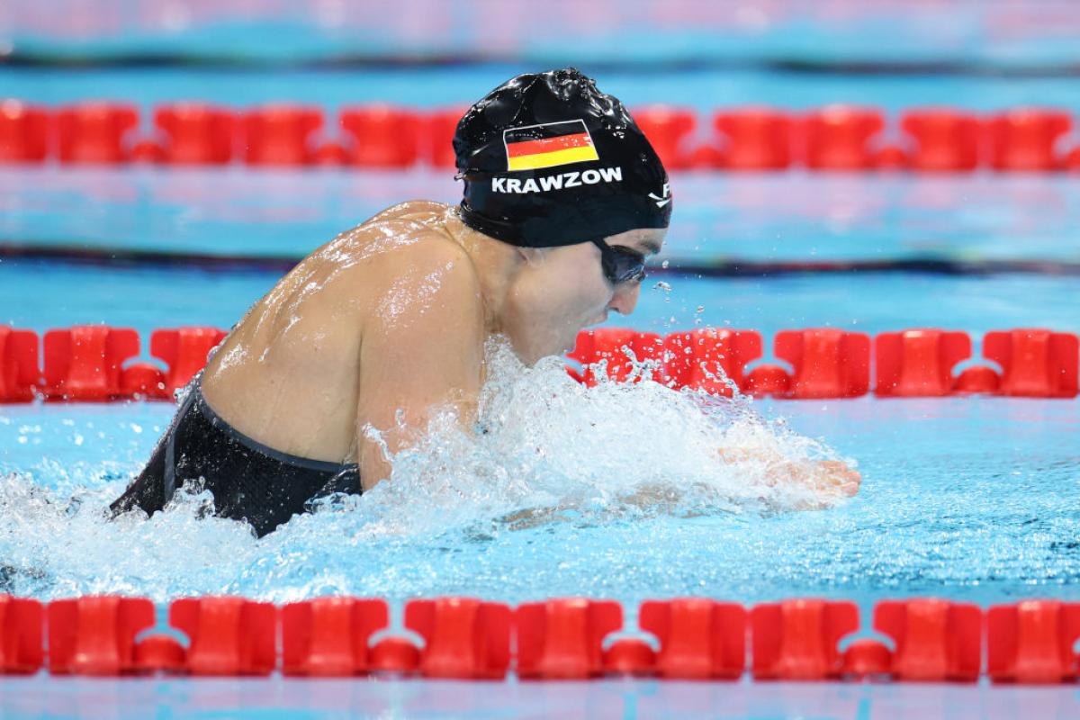 A female swimmer in a breaststroke race