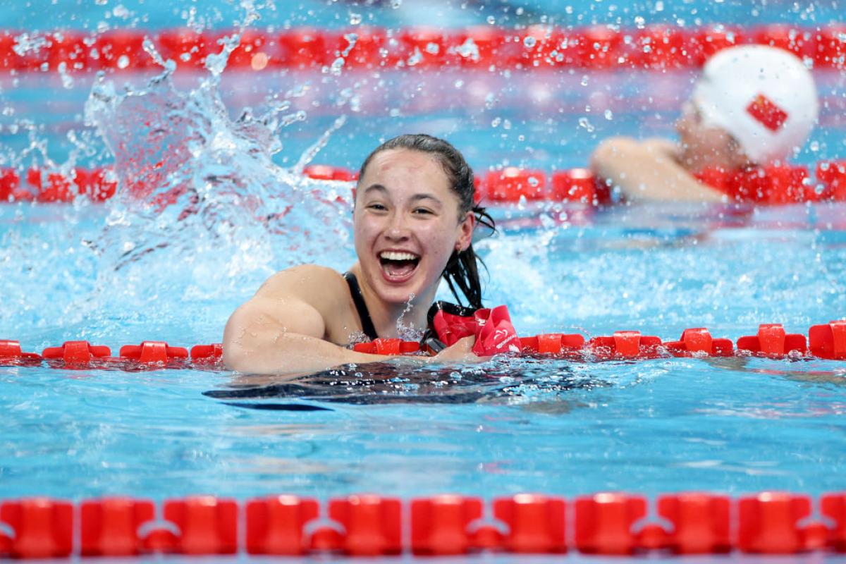 A woman in a swimming pool smiles