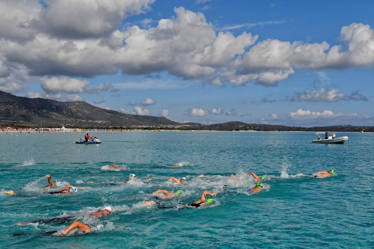 A group of swimmers in an open water event in Sardinia
