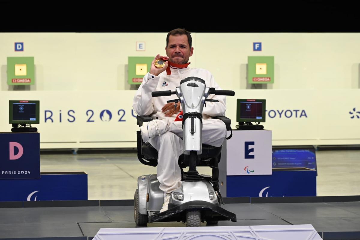 An athlete shows his medal