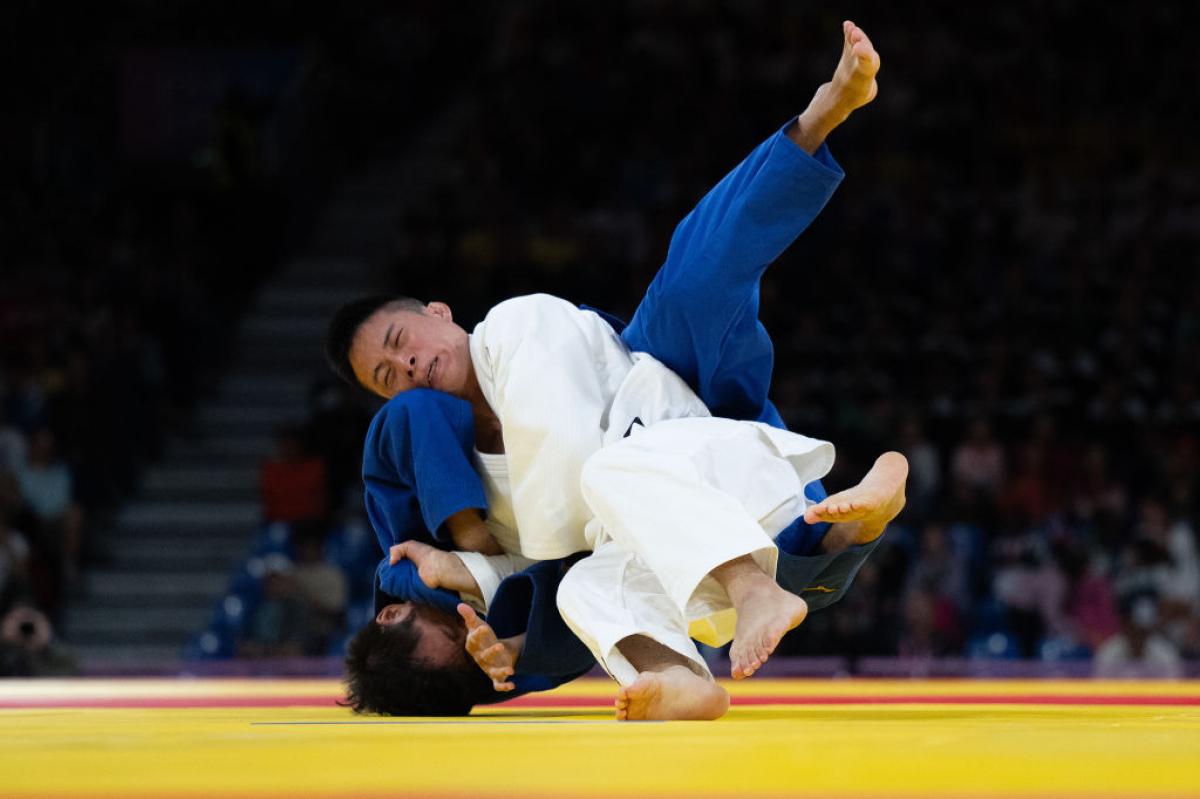 Two judo athletes fighting in a bout