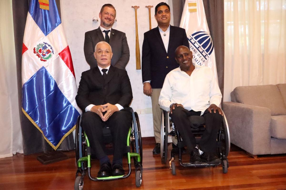 IPC President Andrew Parsons poses for a photo with three male officials