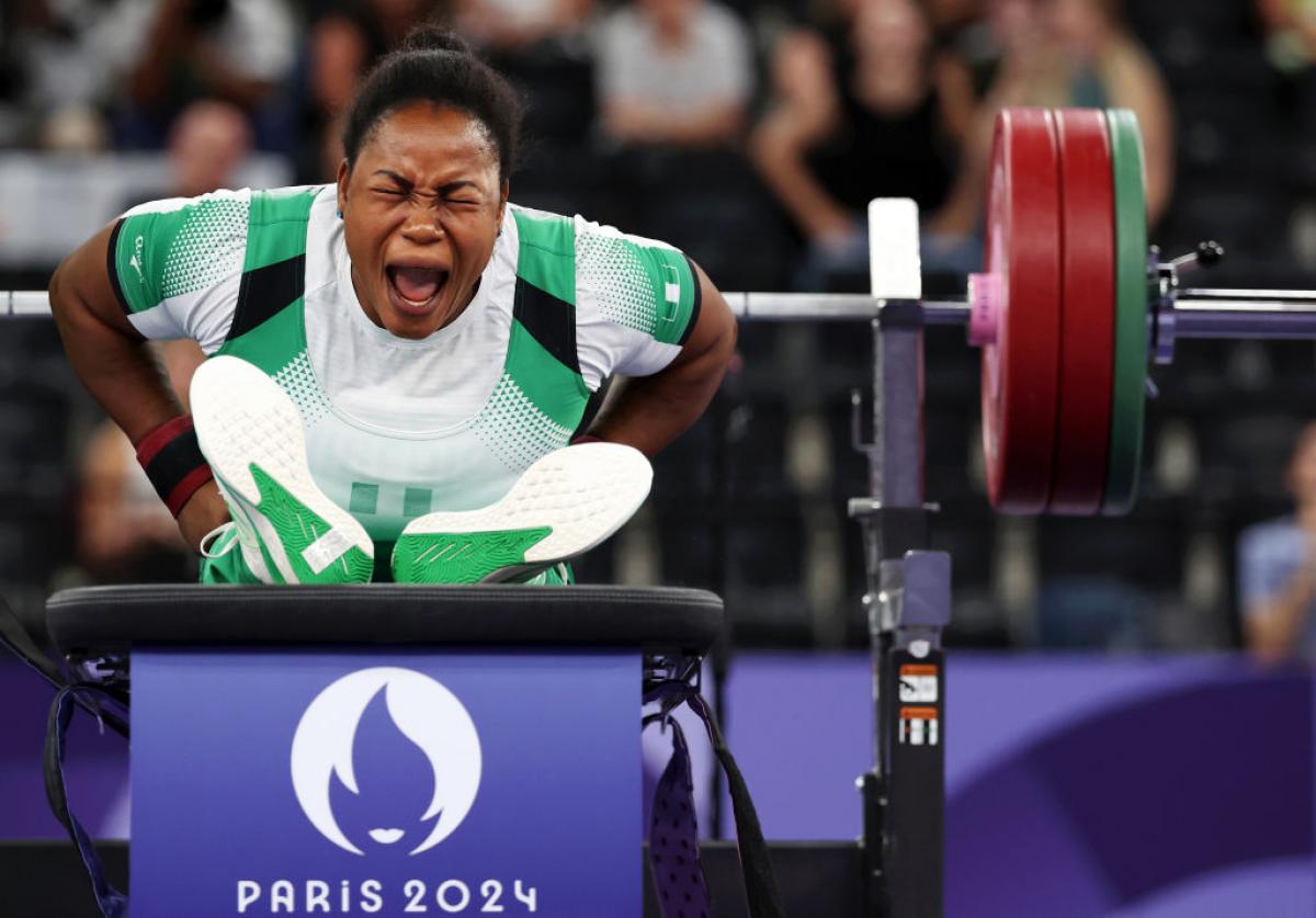 A female Para powerlifter reacts after her lift
