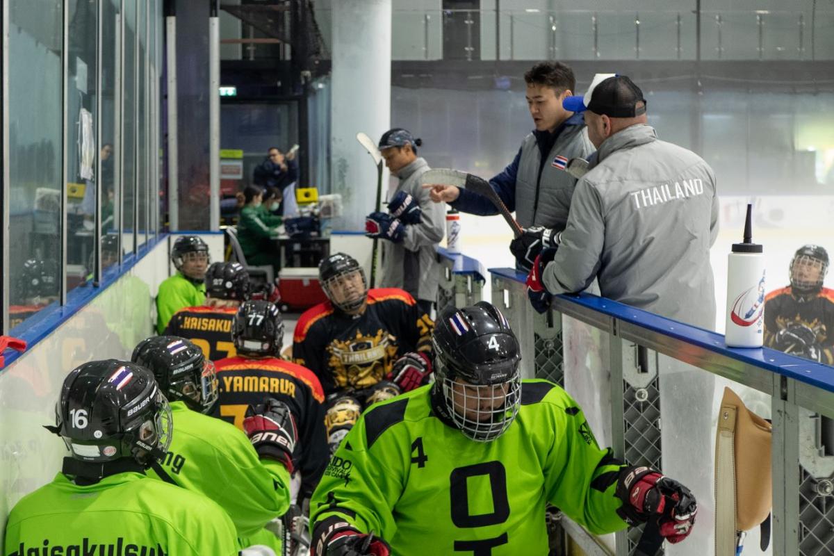 Players enter the ice hockey rink