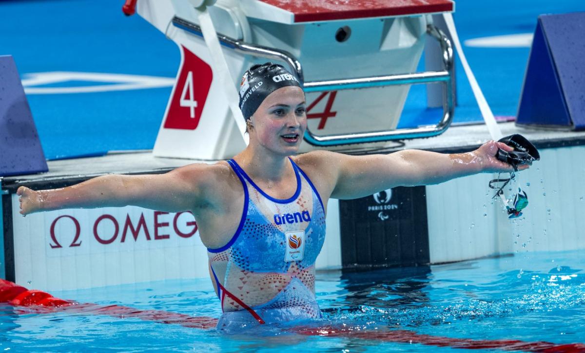 A female Para swimmer stretching her arms in the pool