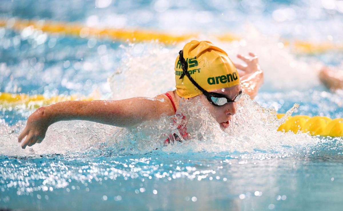 A female athlete with the cap of Australia swimming butterfly