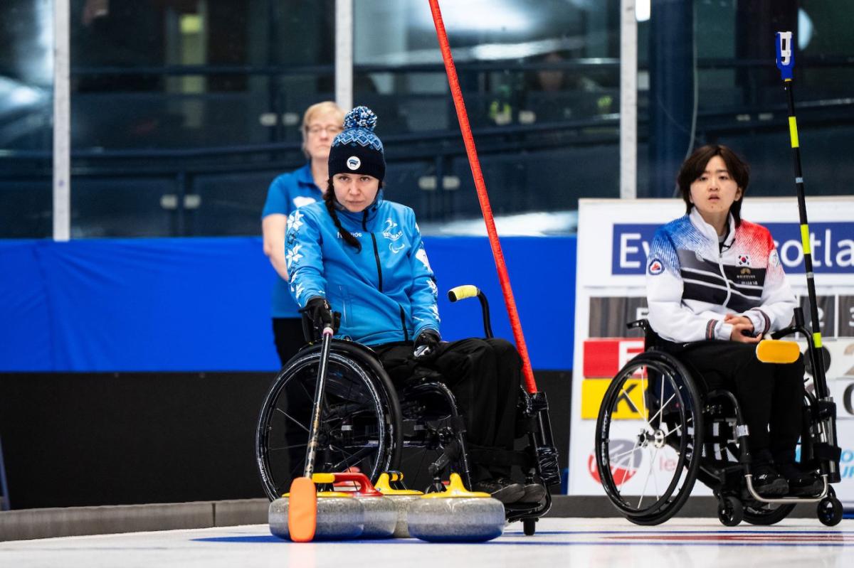 Female wheelchair curling athlete in action