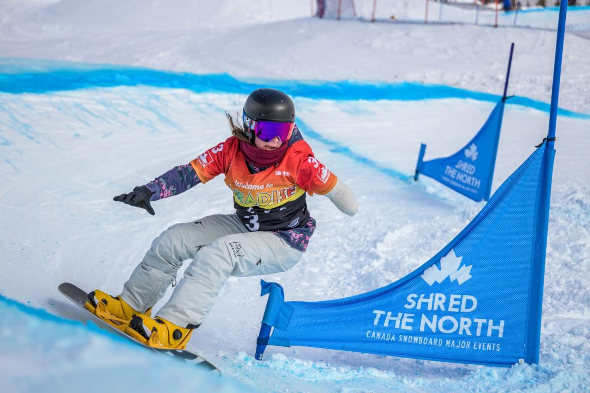 A female Para snowboarding athlete in action